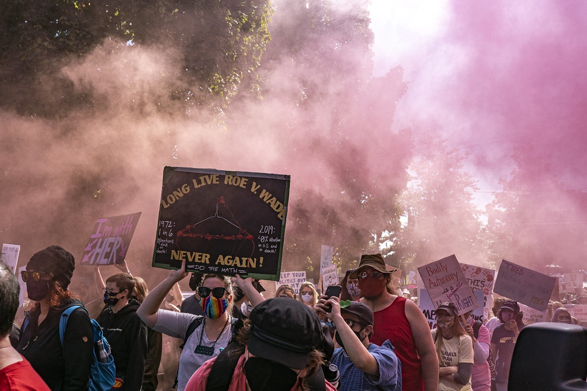 Pro-choice protesters hold signs at a rally