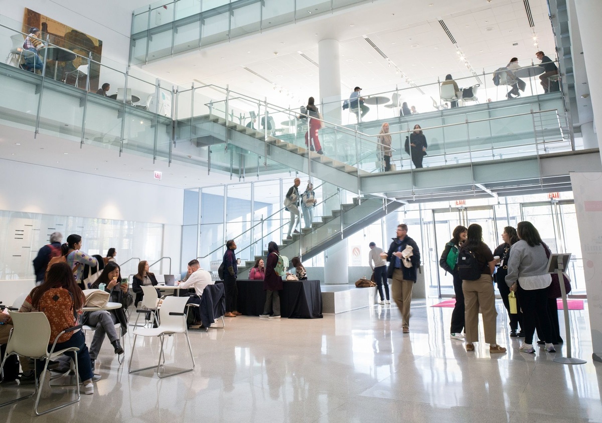 A view of a lobby at the conference venue for the News Product Alliance Summit in 2025, featuring conference participants.